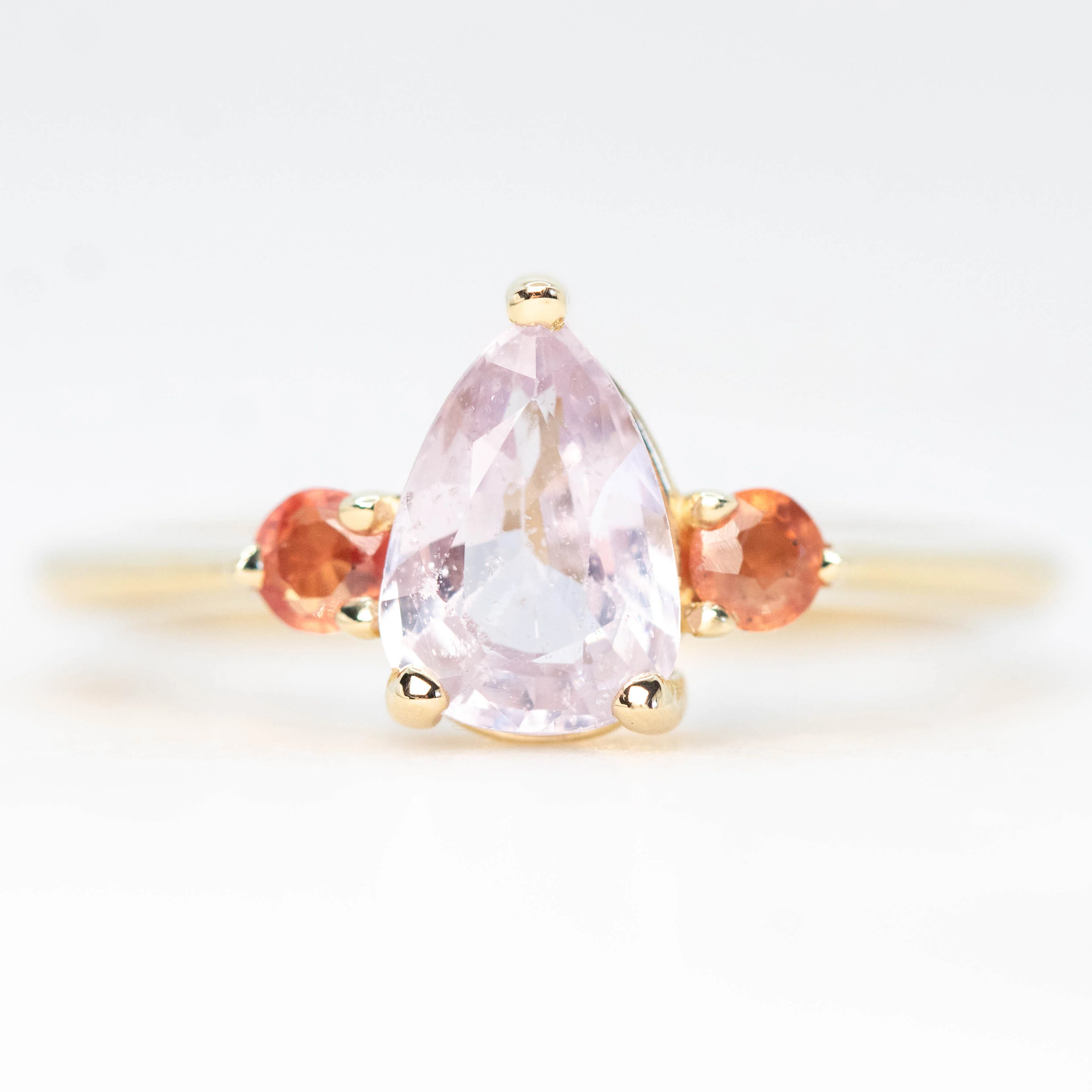 Drea Ring with a 1.32 Carat Pink Pear Sapphire and Orange Sapphire Accents in 14k Yellow Gold - Ready to Size and Ship