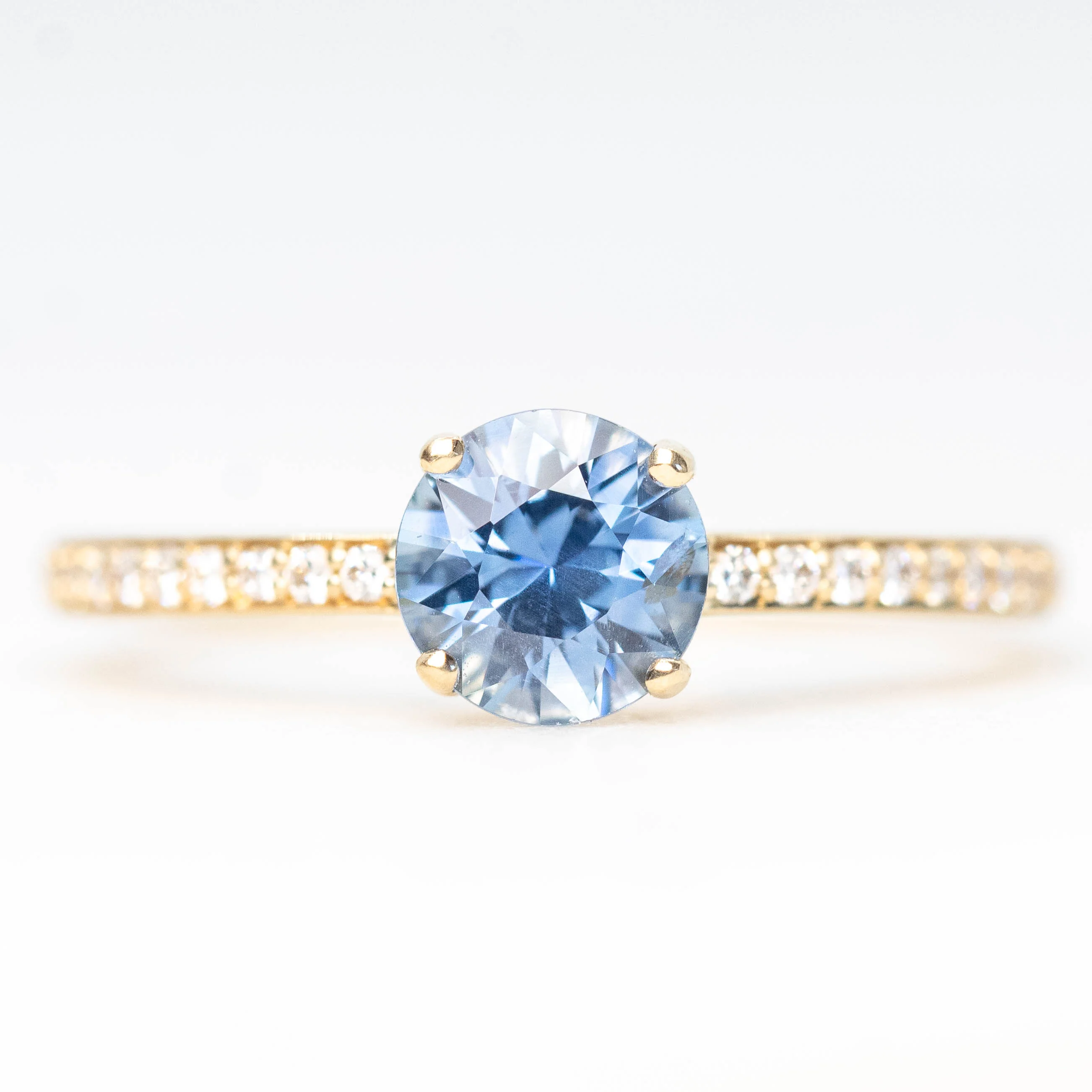 Imani Ring with a 0.96 Carat Round Blue Sapphire and White Accent Diamonds in 14k Yellow Gold - Ready to Size and Ship