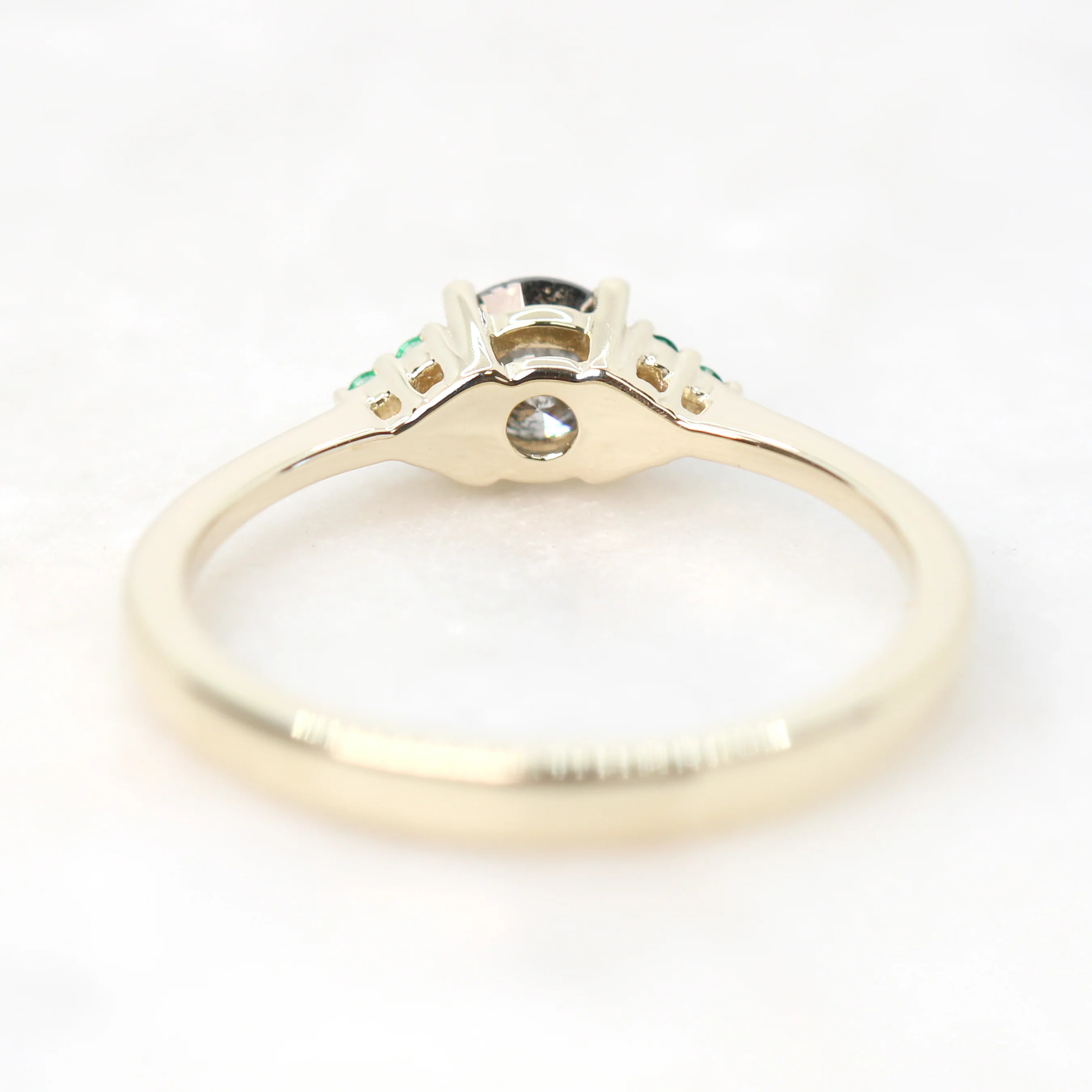 Project: Custom Imogene Ring with a 0.50 Carat Round Dark Gray Black Salt and Pepper Diamond and Emerald Accents in 14k - Image 7