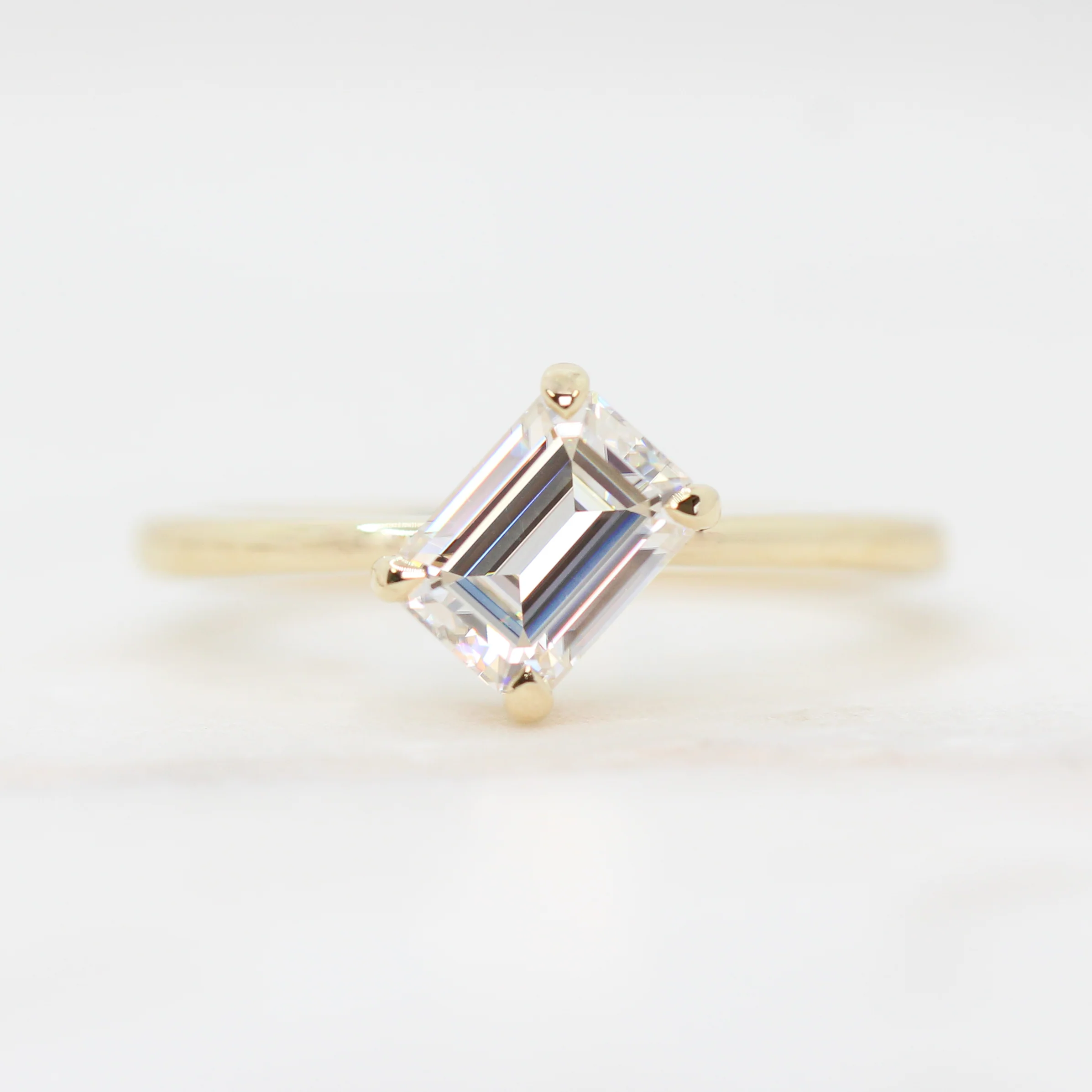 Natalia Ring with a 0.92 Carat White Emerald Cut Moissanite in 14k Yellow Gold - Ready to Size and Ship