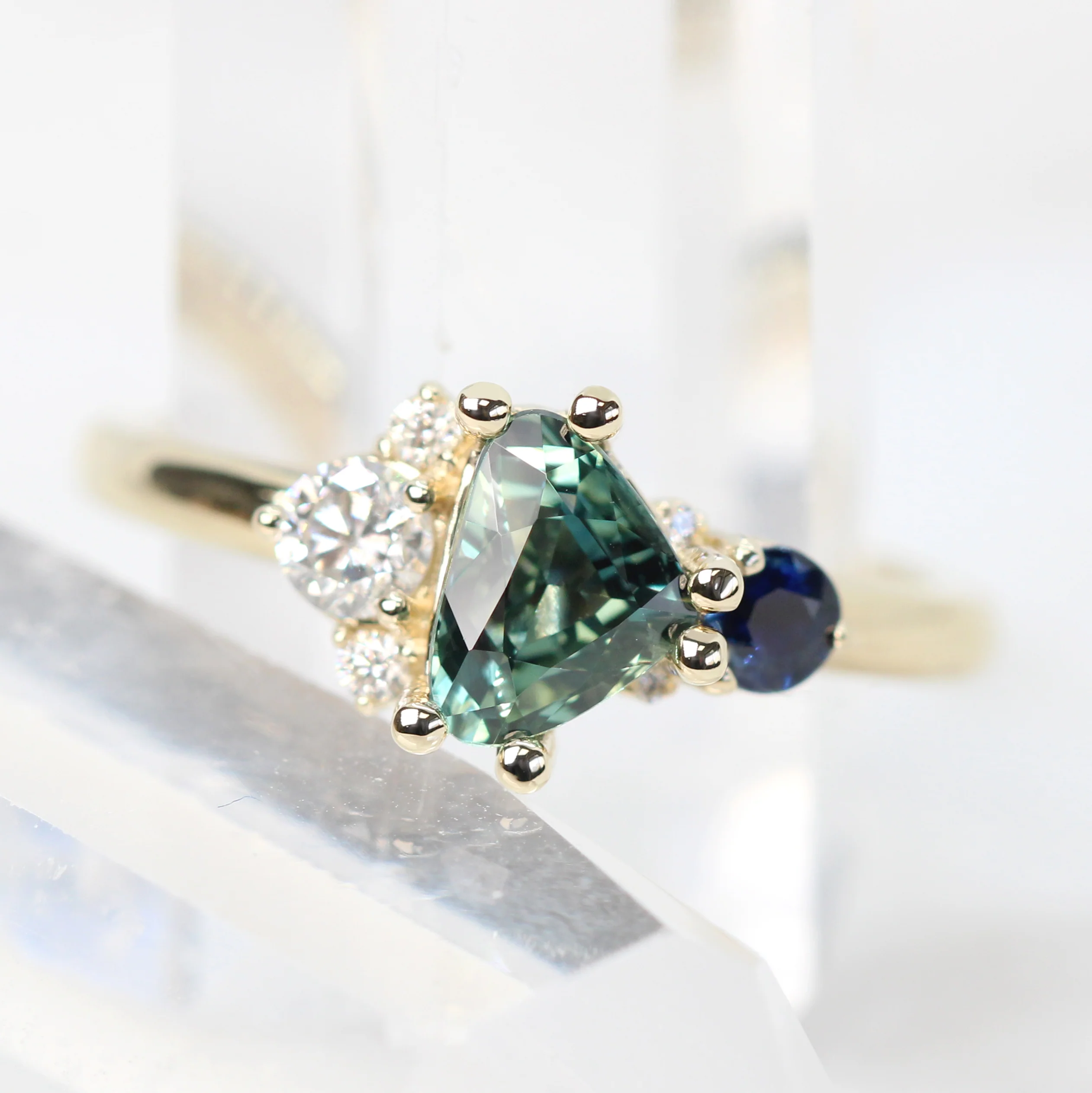 Project: Custom Serena Ring with a 1 Carat Teal Blue Trillion Sapphire and Asymmetrical Accent Diamonds in 14k - Image 2