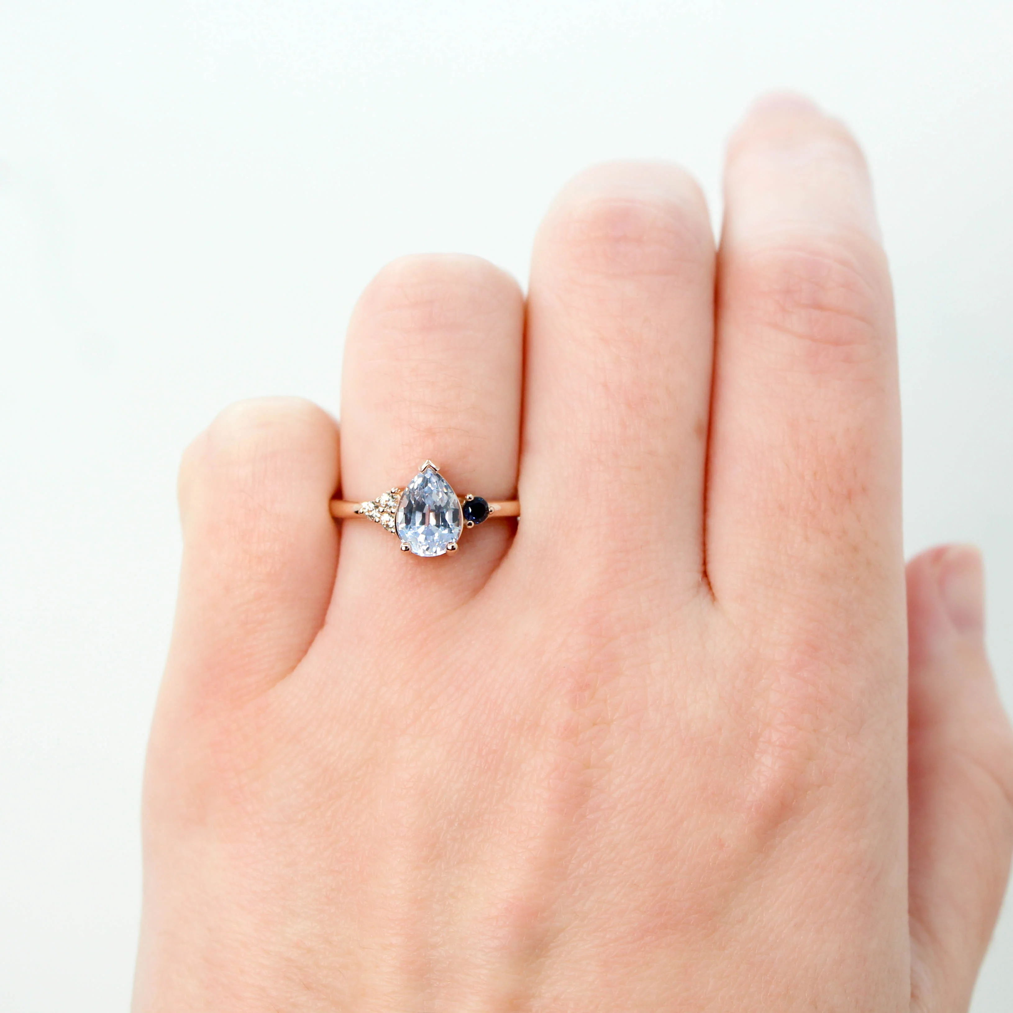 Project: Custom Fletcher Ring with a 2 Carat Blue Pear Sapphire with White and Blue Sapphire Accents in 14k - Image 3