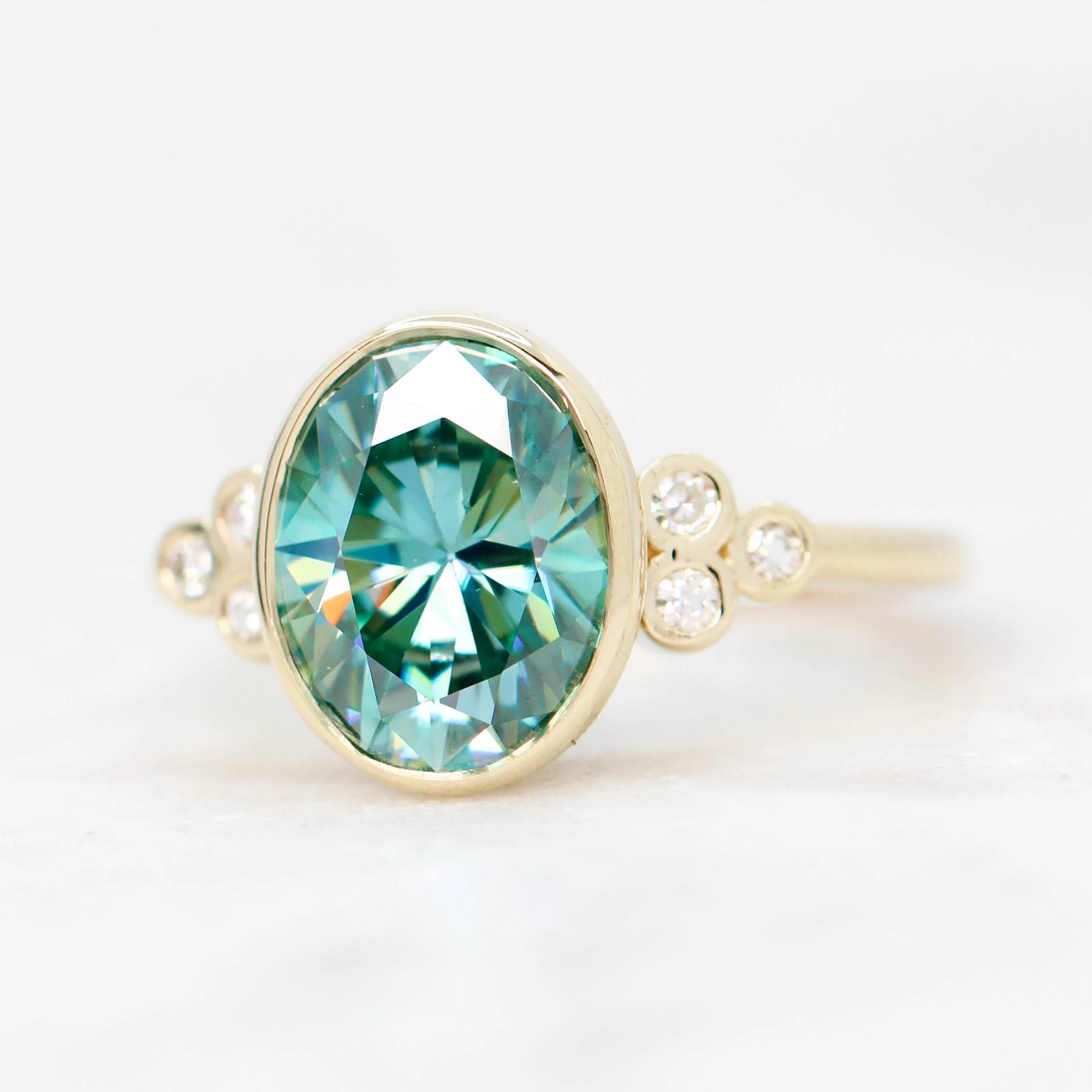 Project: Custom Sophia Ring with a 2.5 Carat Bezel Set Teal Oval Moissanite and Accent Diamonds in 14k - Image 3